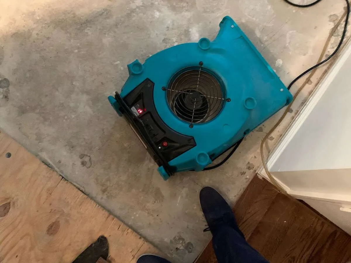 Air mover drying subfloor during Commercial Water Damage Restoration in Channahon